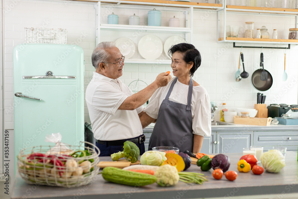 Asian Elderly couple cooking in the home kitchen.