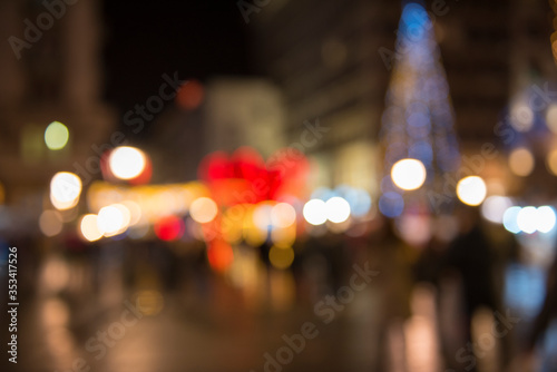 Christmas lights with blur bokeh. Night lights on street. Bokeh light abstract background..