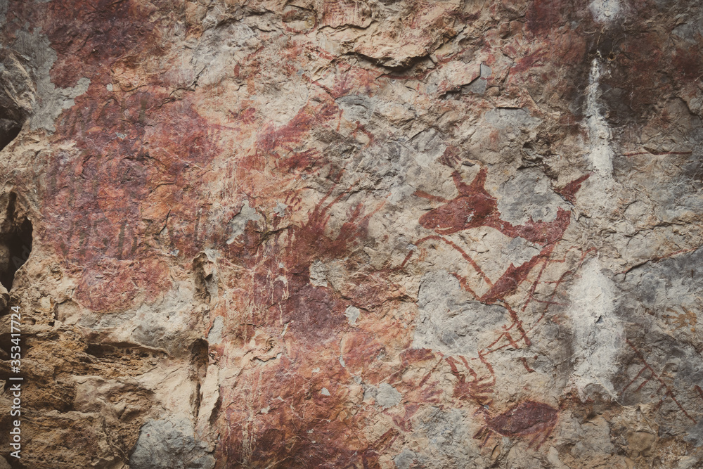 Ancient paintings painted by prehistoric people on the cliffs showing various stories of that era.