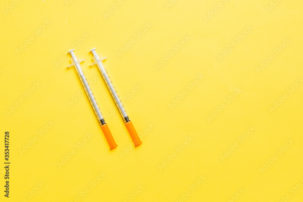 Top view of insulin syringes ready for injection on colorful background. Diabetic concept with copy space Top view of insulin syringes ready for injection on colorful background. Diabetic concept with copy space