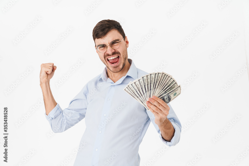 Photo of delighted man holding dollars and making winner gesture Photo of delighted man holding dollars and making winner gesture