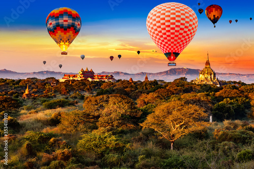 Sunrise over Bagan ruins with hot air balloons in the sky
