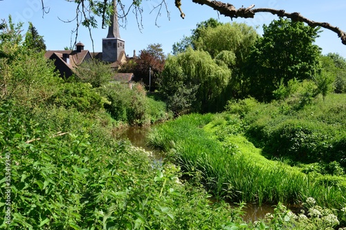 A church in the background of the winding River Mole in Horley, Surrey. photo