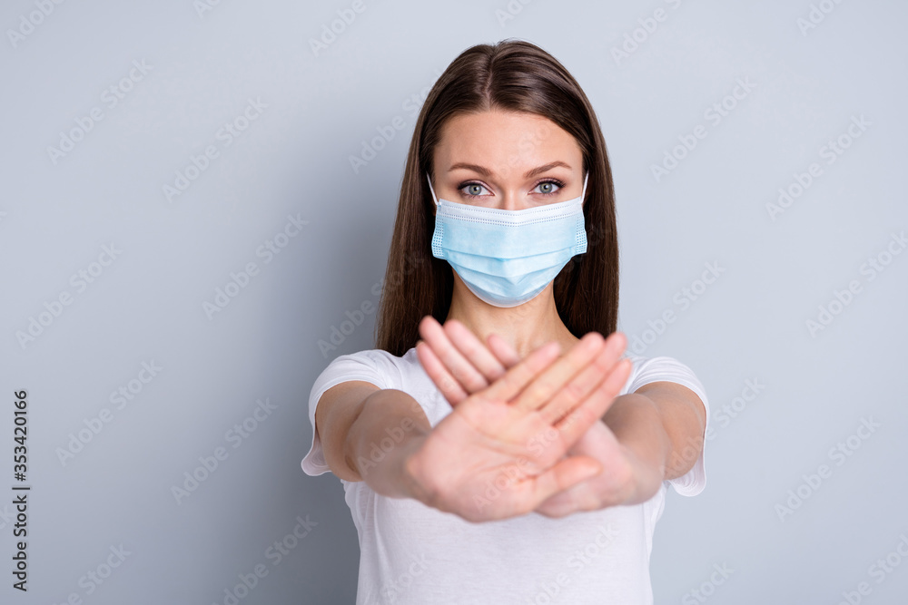 Photo of pretty serious lady keep social distance avoid people contacting hospital examination raise crossed arms standing far wear protect face mask t-shirt isolated grey color background Photo of pretty serious lady keep social distance avoid people contacting hospital examination raise crossed arms standing far wear protect face mask t-shirt isolated grey color background
