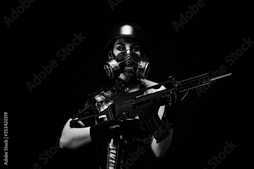 Portrait of a female cyborg soldier wearing a gas mask, helmet and an assault rifle