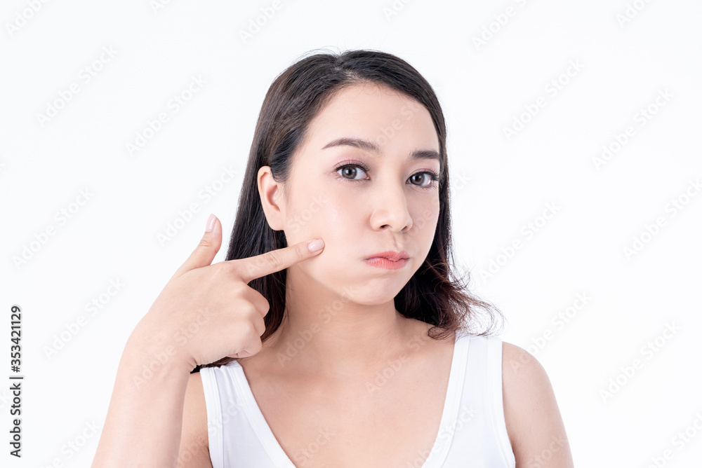 Portrait images of Asian young, pretty woman is 25 years old, She is using finger to touch the skin on the cheeks, On white background, to people and beauty concept Portrait images of Asian young, pretty woman is 25 years old, She is using finger to touch the skin on the cheeks, On white background, to people and beauty concept