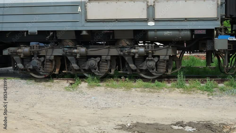 Close up of train wheels and wagons of an ore train pass by the camera. Close up of train wheels and wagons of an ore train pass by the camera.