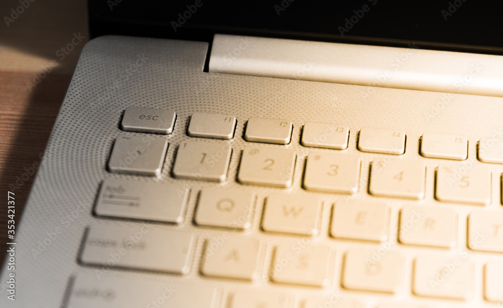 Close up detail view of laptop computer metalic keyboard on wooden table for Business idea concept background Close up detail view of laptop computer metalic keyboard on wooden table for Business idea concept background