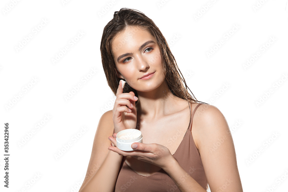 Natural moisturizer. Close up of beautiful young woman with cream on white background. Concept of cosmetics, makeup, natural and eco treatment, skin care. Shiny and healthy skin, fashion, healthcare. Natural moisturizer. Close up of beautiful young woman with cream on white background. Concept of cosmetics, makeup, natural and eco treatment, skin care. Shiny and healthy skin, fashion, healthcare.