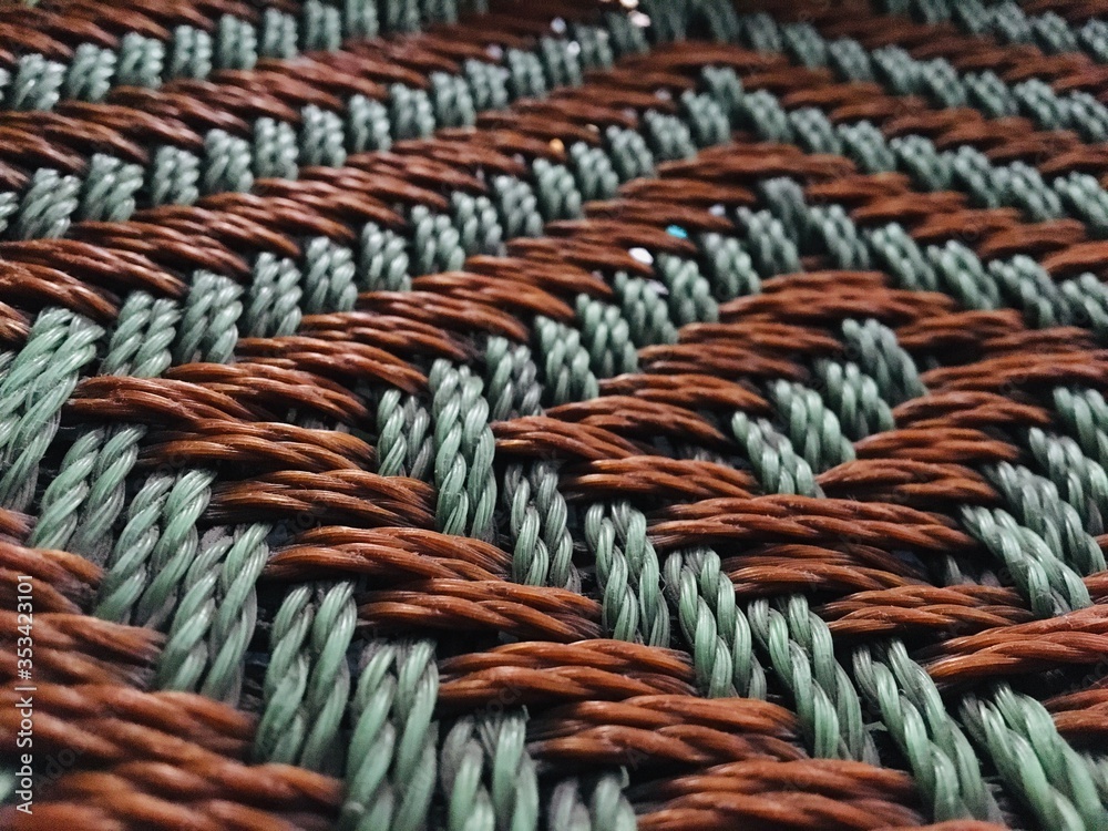 close up of a rope green and orange on a white background