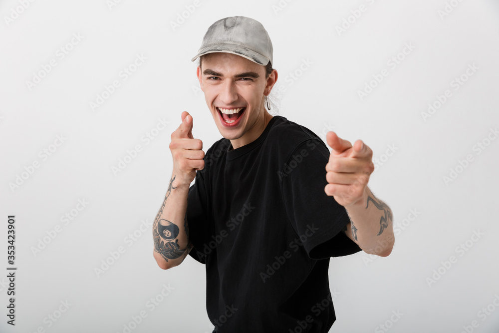 Portrait closeup of laughing man wearing black clothes looking and pointing fingers at camera Portrait closeup of laughing man wearing black clothes looking and pointing fingers at camera