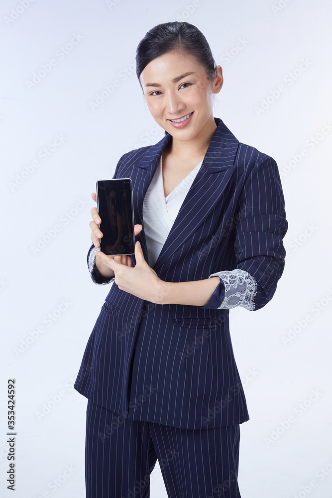 Choice it! Technology, mobile, equipment for communication. Young beautiful woman shows right in camera the blank screen of smart phone on white background Choice it! Technology, mobile, equipment for communication. Young beautiful woman shows right in camera the blank screen of smart phone on white background