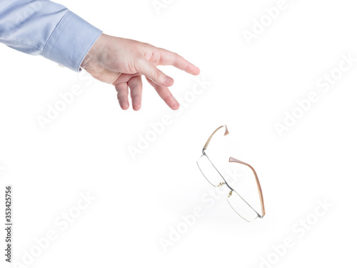 Man's hand throws down the glasses