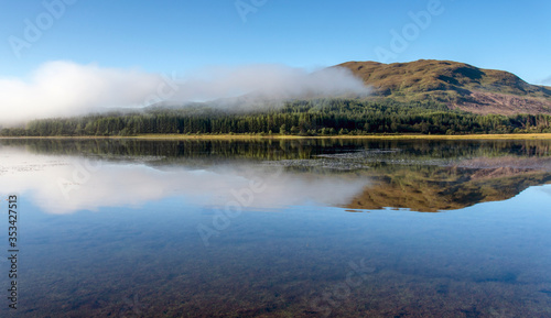 Misty dawn on Loch Eil calm with perfect reflections