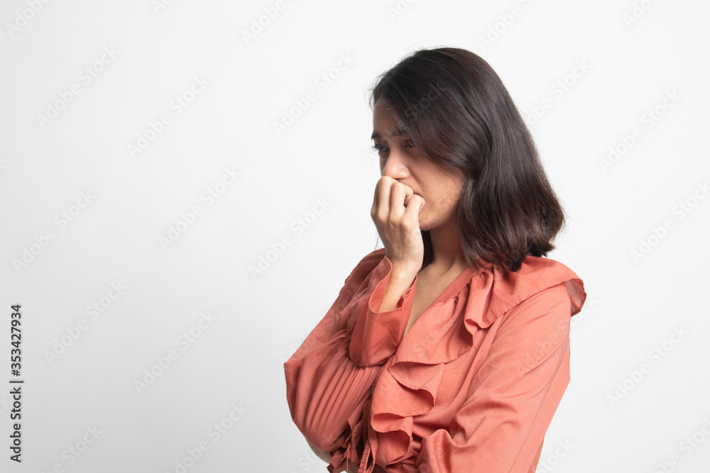 Unsure hesitant nervous young asian woman biting her fingernails . Unsure hesitant nervous young asian woman biting her fingernails .
