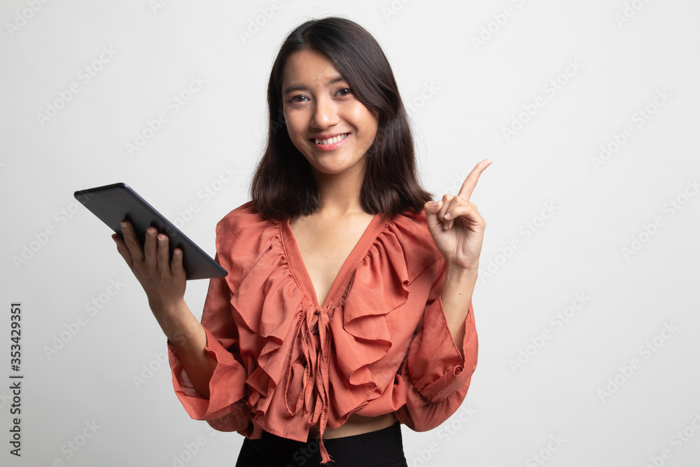 Young Asian woman with a computer tablet . Young Asian woman with a computer tablet .