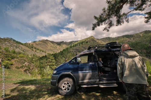 Dad and son in car off road mountain travel  summer vacation