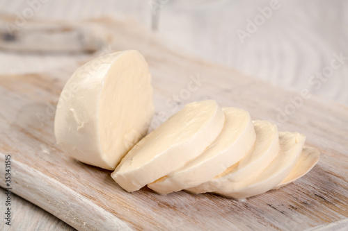 Fresh cheeses on white wood. National cheeses prepared according to ancient recipes