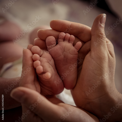 Little tiny baby legs in hands