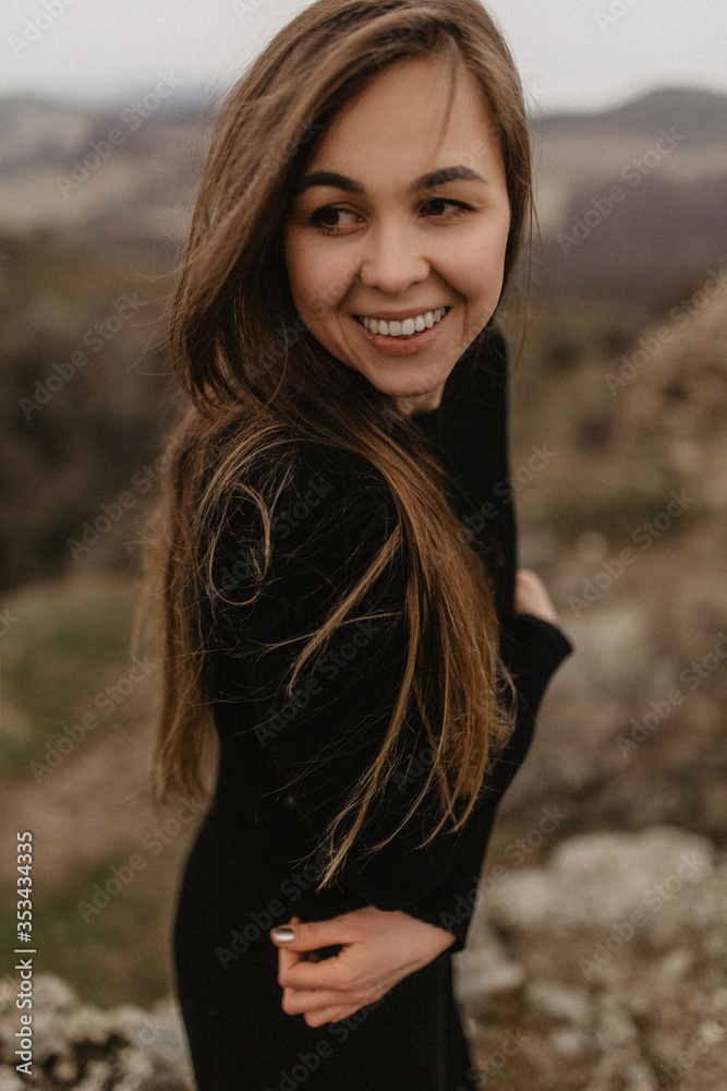 Young woman smiling in the black dress Young woman smiling in the black dress