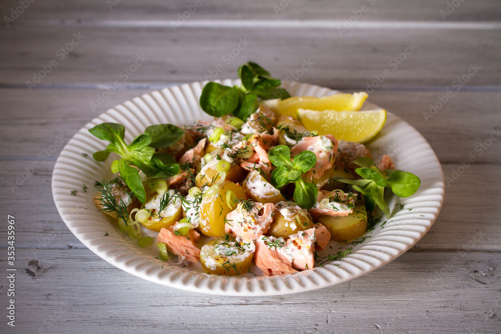 Poached Salmon salad with baby potatoes and yogurt dressing. Horizontal image Poached Salmon salad with baby potatoes and yogurt dressing. Horizontal image