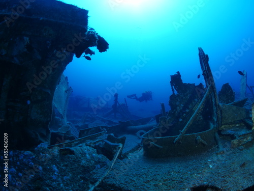 scuba divers exploring ship wreck scenery underwater shipwreck metal on the ocean floor © underocean