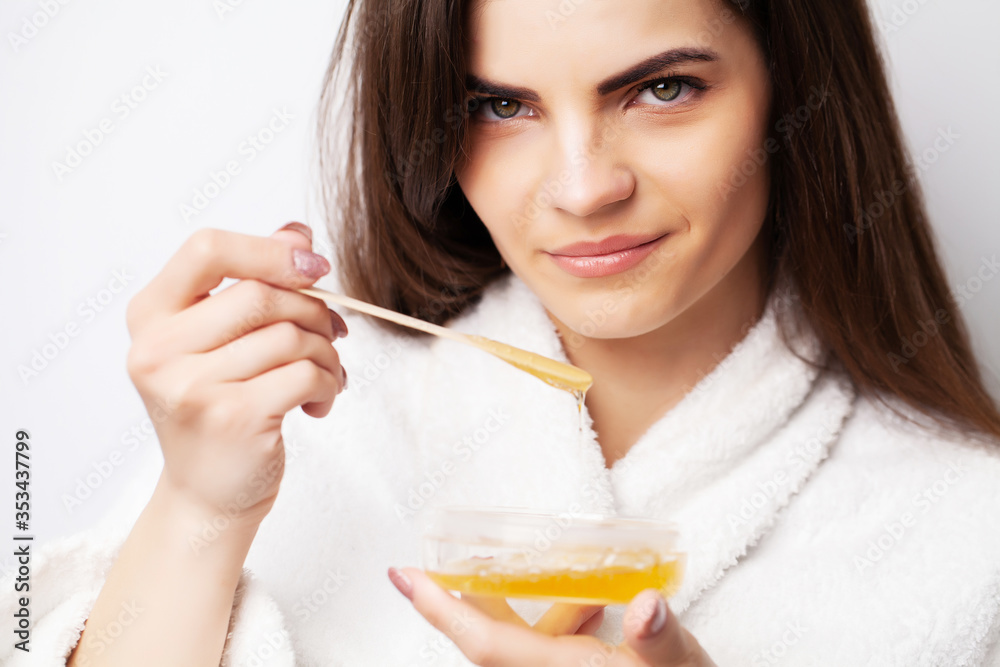 Care concept, woman holding bowl with wax for hair removal Care concept, woman holding bowl with wax for hair removal