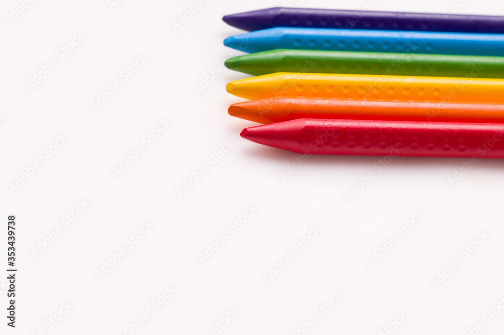 The concept of children's creativity drawing. Crayons on a white background. Copy space. Banner The concept of children's creativity drawing. Crayons on a white background. Copy space. Banner