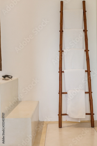 White towels on bamboo ladder in bathroom