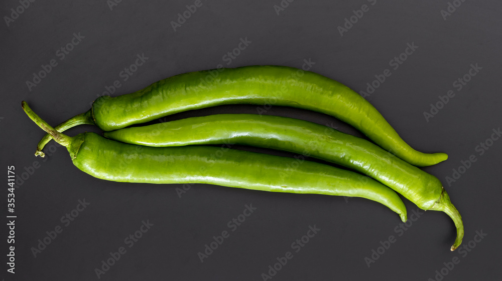 three green pepper on grey background. food and vegetable concept wallpaper. three green pepper on grey background. food and vegetable concept wallpaper.