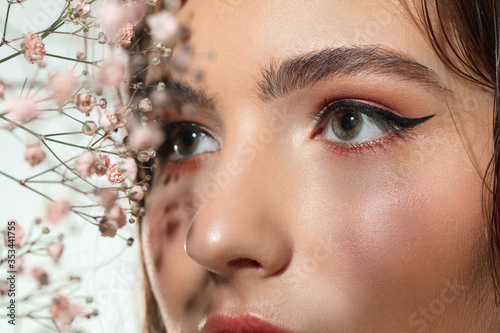 Soft. Close up of beautiful female eyes with eyeliner and mascara on white background. Concept of cosmetics, makeup, natural and eco treatment, skin care. Shiny and healthy skin, fashion, healthcare.