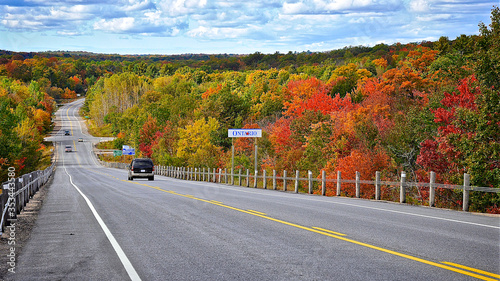 Milford Bay, Ontario / Canada - 10/05/2008: Mountain road. Landscape with rocks, autumn leaf color, and beautiful asphalt road in autumn. High angle view....