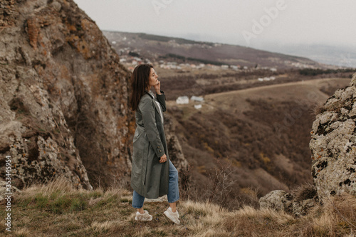 young woman standing on top of the mountain