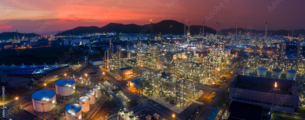 Aerial view. Oil refinery factory and oil storage tank at twilight. Petrochemical Industrial. Banner panorama background
