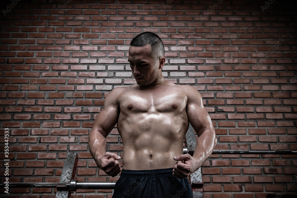 Fototapeta premium Portrait of asian man big muscle at the gym,Thailand people,Workout for good healthy,Body weight training,Fitness at the gym concept