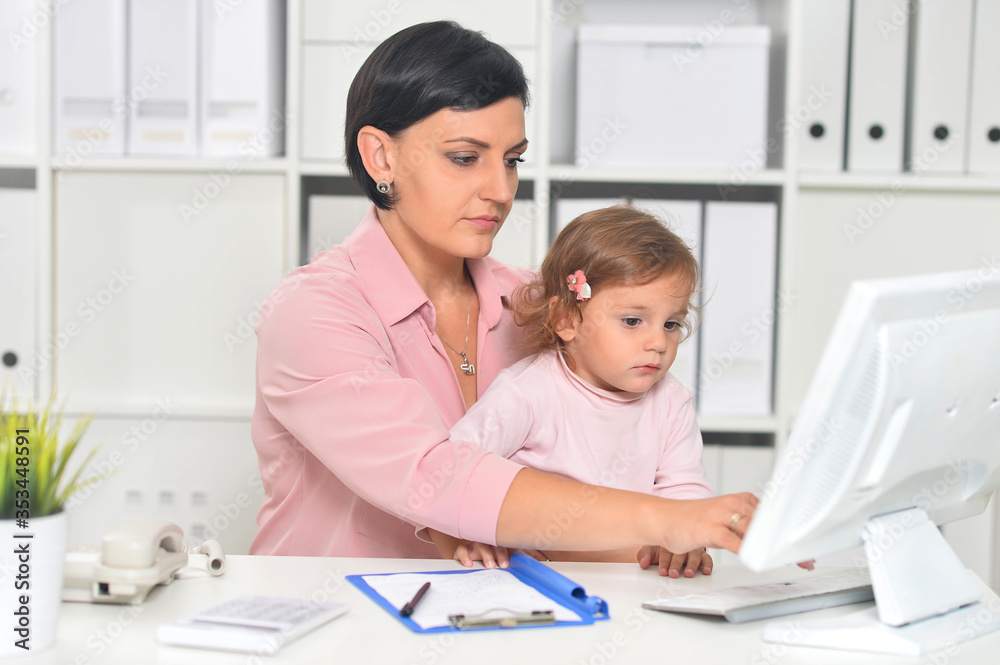 Businesswoman with her child working in office