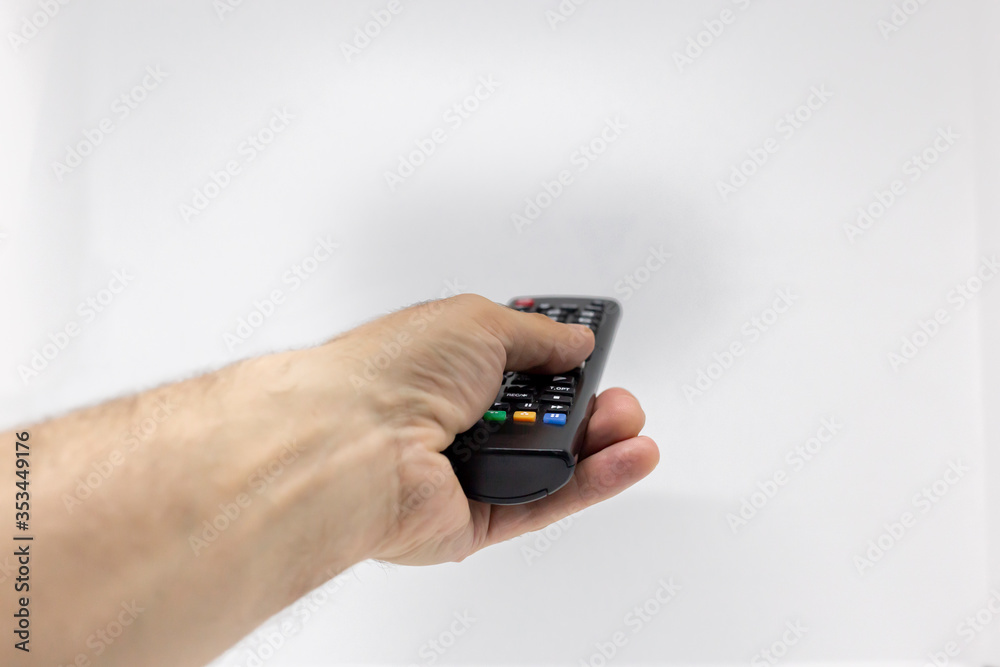 Hand holding a tv remote controller Hand holding a tv remote controller