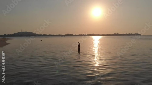 Women into the sunset over the sea