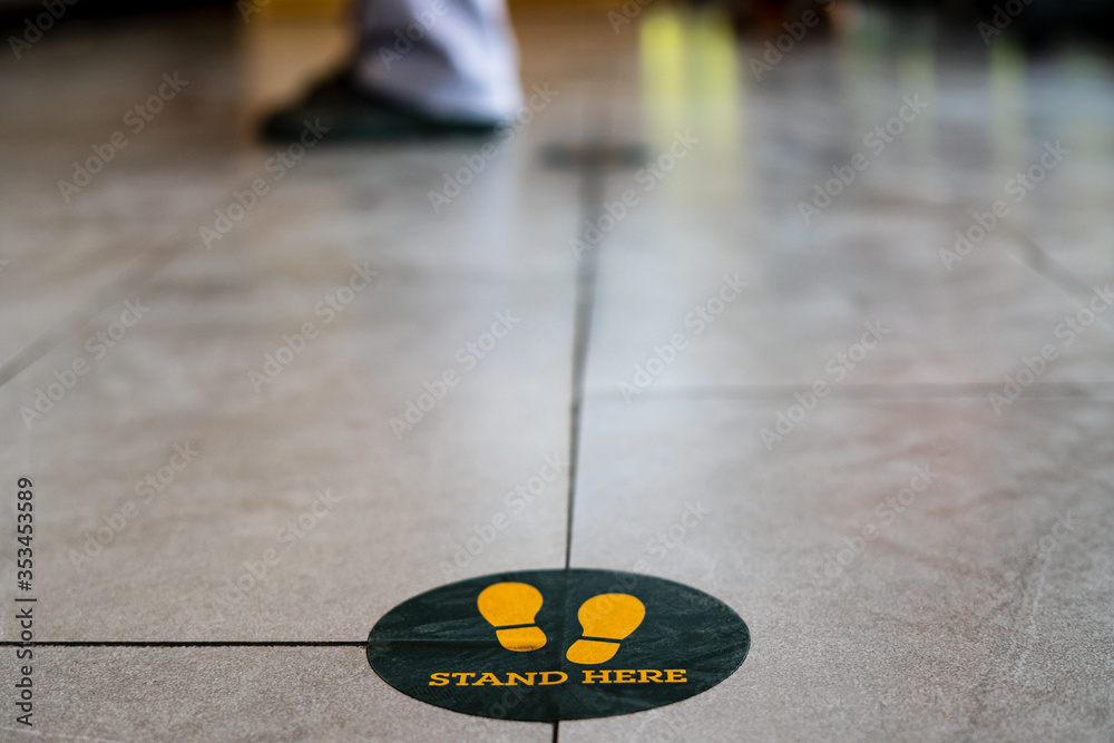 Fototapeta premium Stand here foot sign or symbol on the floor in coffee shop