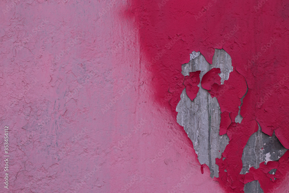 The wall is painted in pink and raspberry color, raspberry paint has partially fallen off. A photo was taken close for your street design. The wall is painted in pink and raspberry color, raspberry paint has partially fallen off. A photo was taken close for your street design.