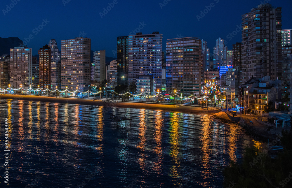 Obraz premium Night city by the sea with an empty beach and beautiful night lighting, Summer background