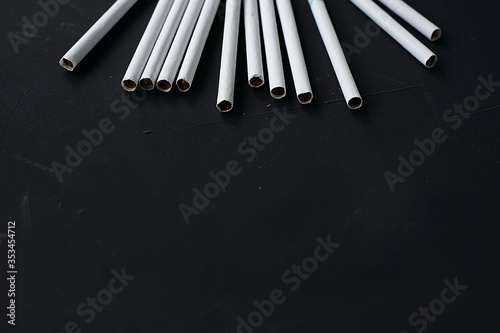 White thin cigarettes with xs filter on a black background