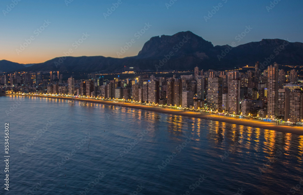Fototapeta premium Night city by the sea with an empty beach and beautiful night lighting, Summer background