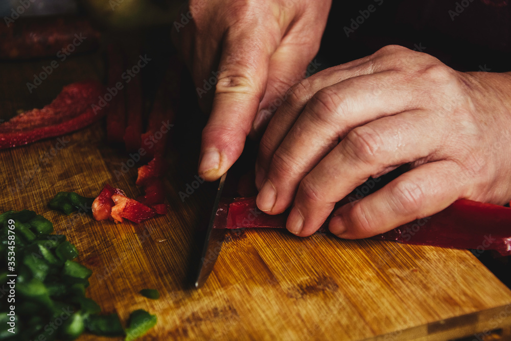 Obraz premium Woman slicing red pepper