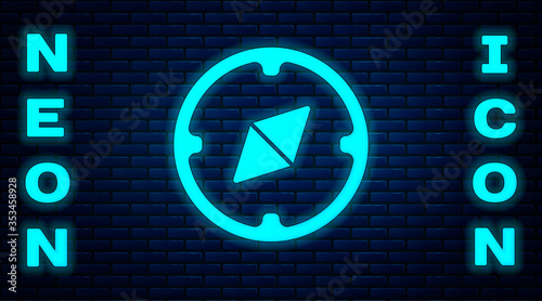 Glowing neon Compass icon isolated on brick wall background. Windrose navigation symbol. Wind rose sign. Vector Illustration.