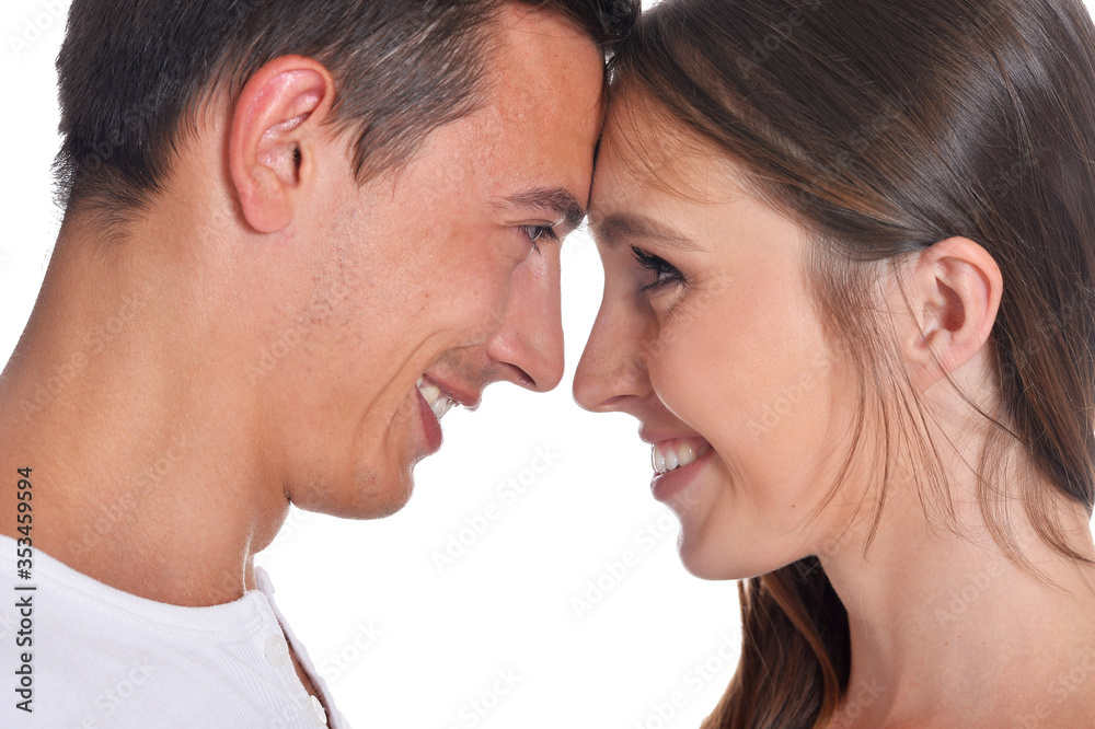 Happy beautiful young couple posing on white background