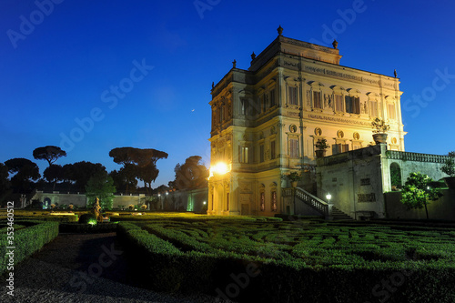 night view at dusk of the Algardi cottage inside the public park of Villa Pamphili in Rome, Italy