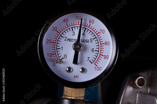 Air compressor manometer close-up. Pressure gauge measurement. photo