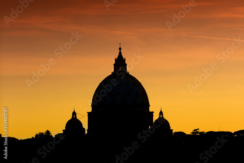 stunning silhouette view of the dome of basilica San Pietro, saint Peter cathedral, in Rome at red sunset, backlight
