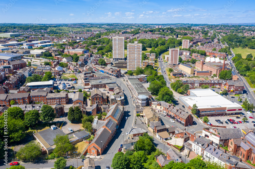 Aerial photo of the town centre of Armley in Leeds West Yorkshire on a bright sunny summers day showing apartment blocks flats and main roads going in to the town